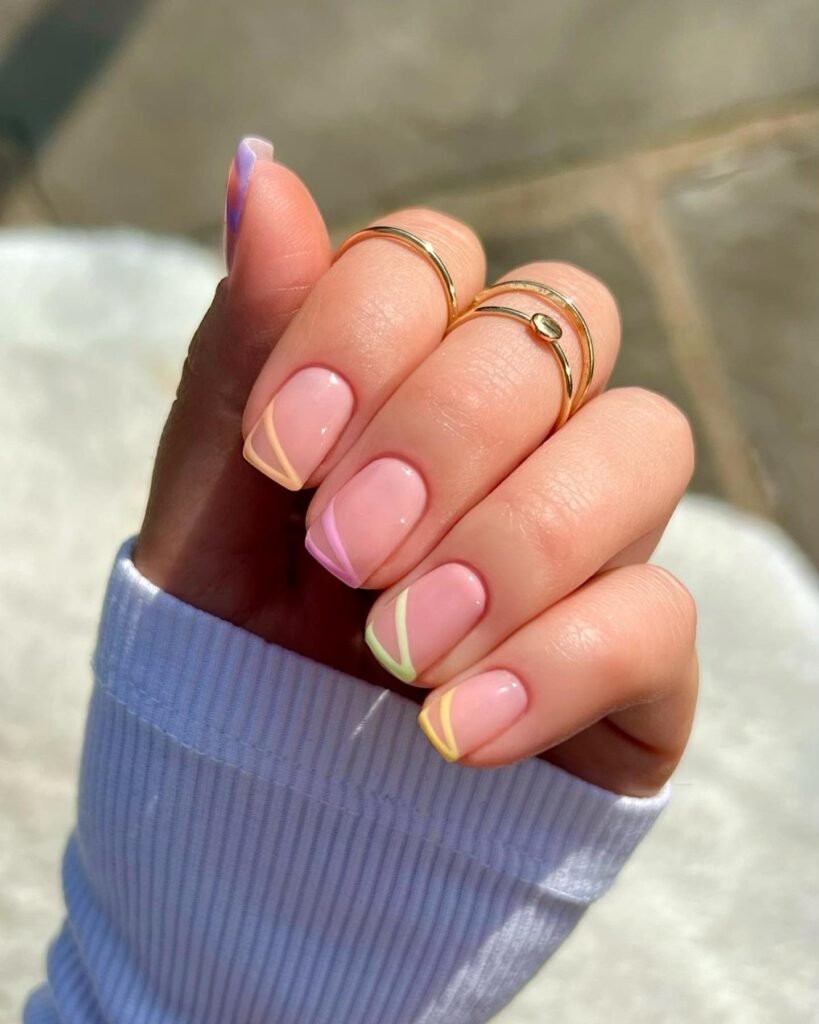 Minimal French tip manicure with wavy pastel outlines in yellow, green, and pink 