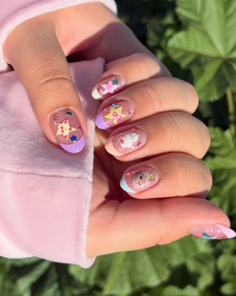 Pastel purple French tip nails decorated with stars, hearts, and small gems outdoors.