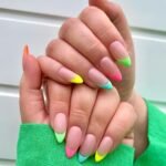 Bright neon French tip manicure with mint, yellow, pink, and lime colors on nude base