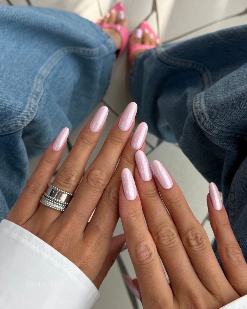 Long pink nails styled with jeans and bright pink pointed sandals.