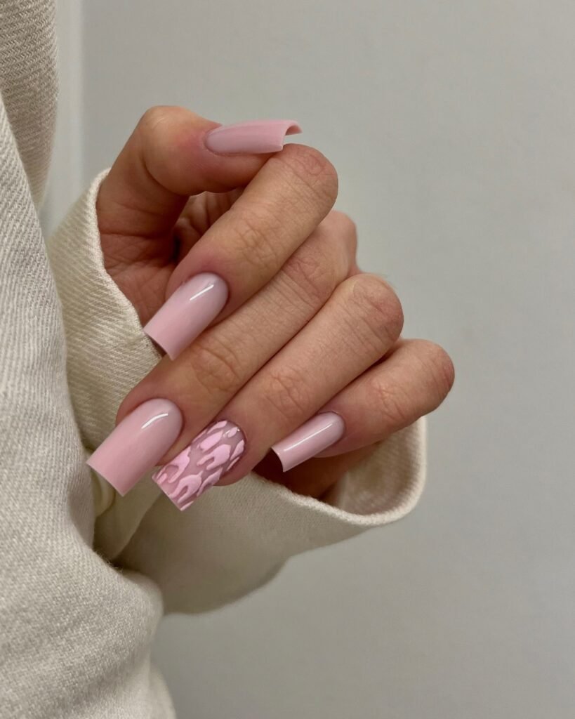 Soft pink short nails with glossy texture and a cozy cream sweater.