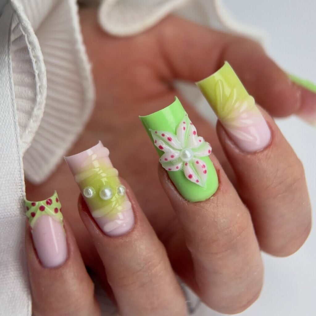 Short mint nails with colorful confetti flowers and glossy pastel finish.
