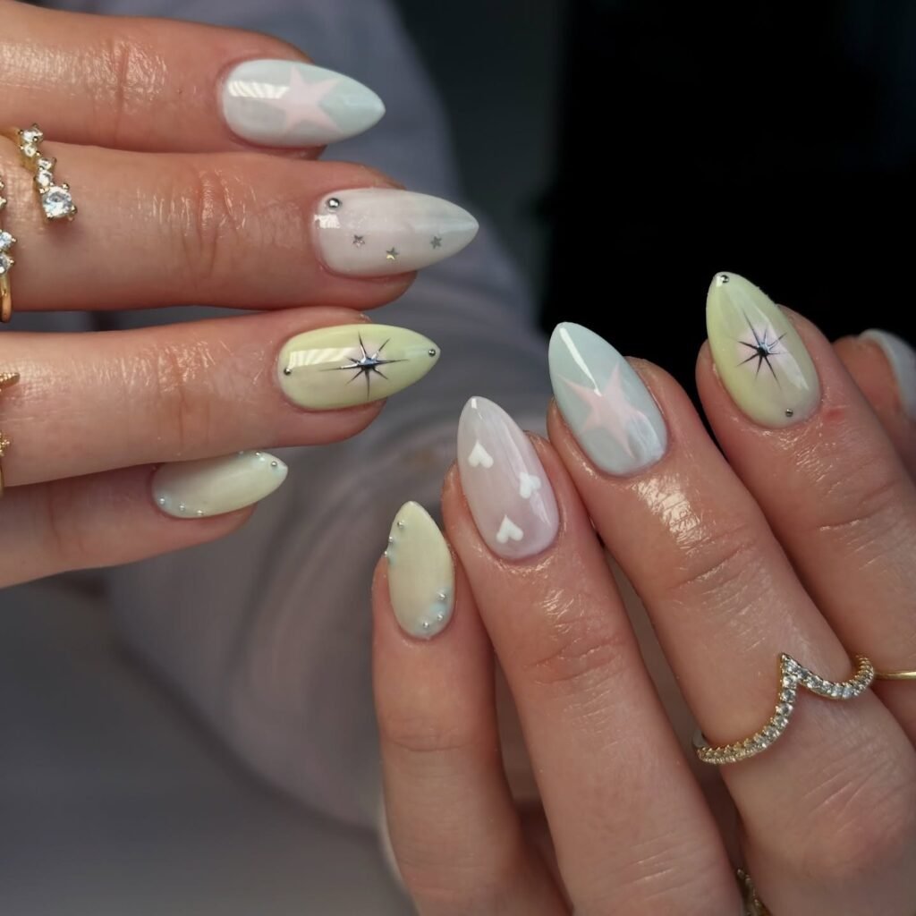 pastel y2k nails with stars hearts and silver studs