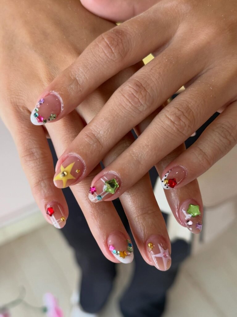 y2k nails with colorful rhinestones and white french tips