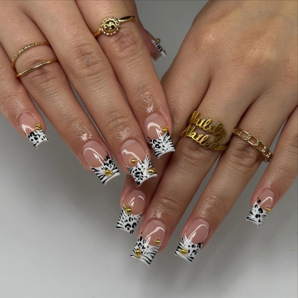 y2k zebra french tip nails with gold charms