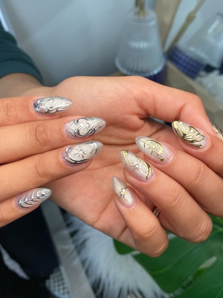 metallic y2k nails with celestial chrome star designs