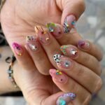 colorful y2k nails with rhinestones stars and patterned tips