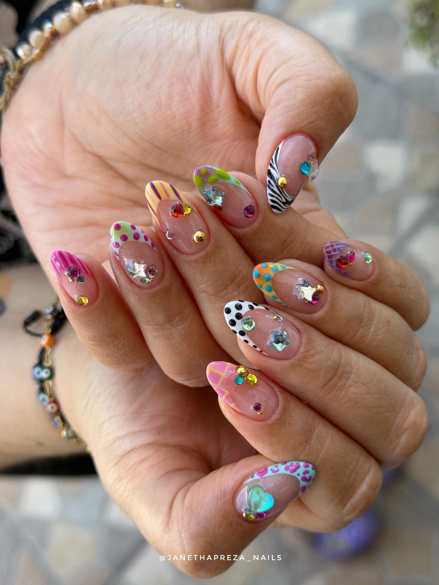 colorful y2k nails with rhinestones stars and patterned tips