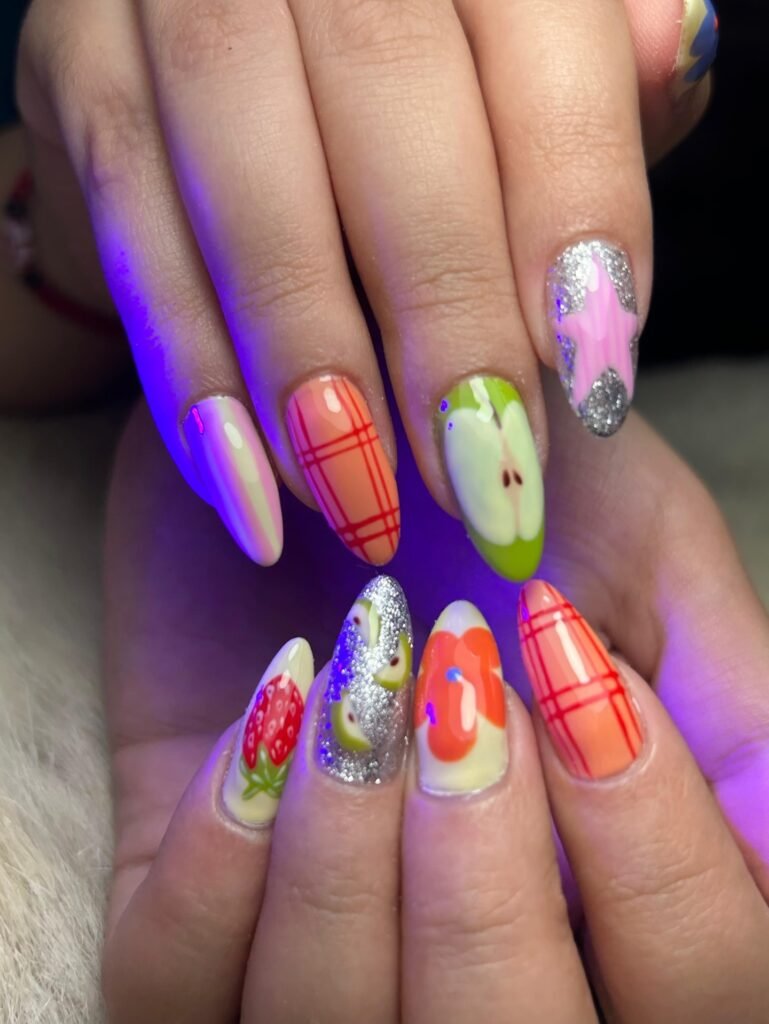 funky y2k nails with fruit plaid and glitter accents