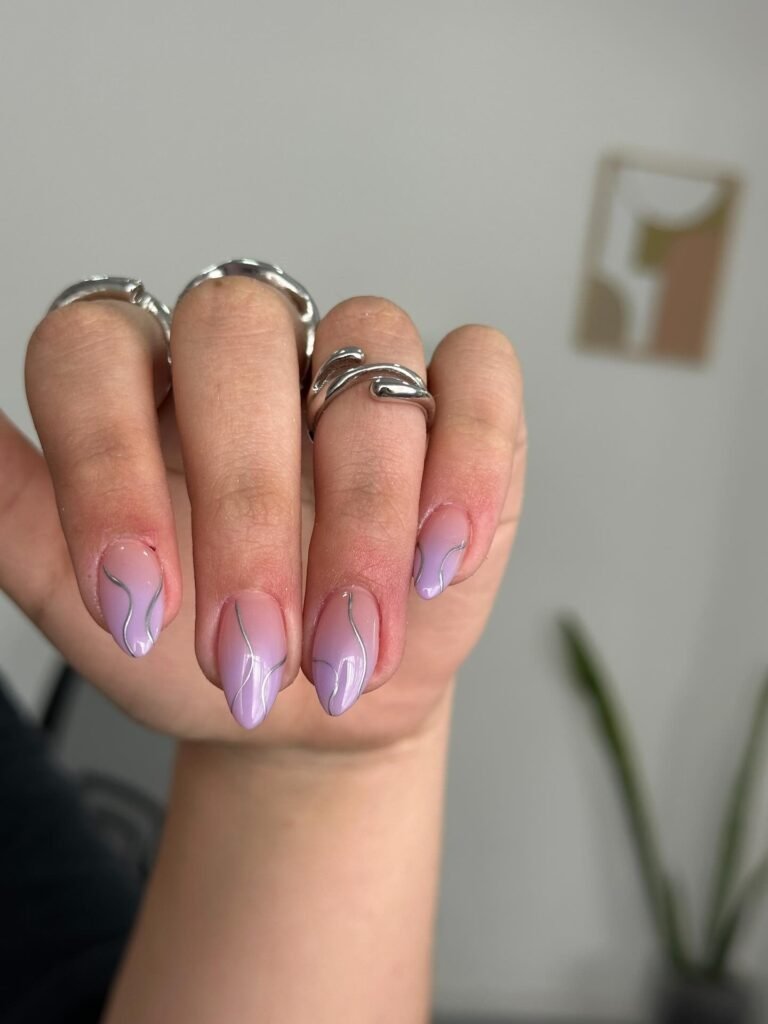 Lavender almond nails with elegant silver line art details and shine.