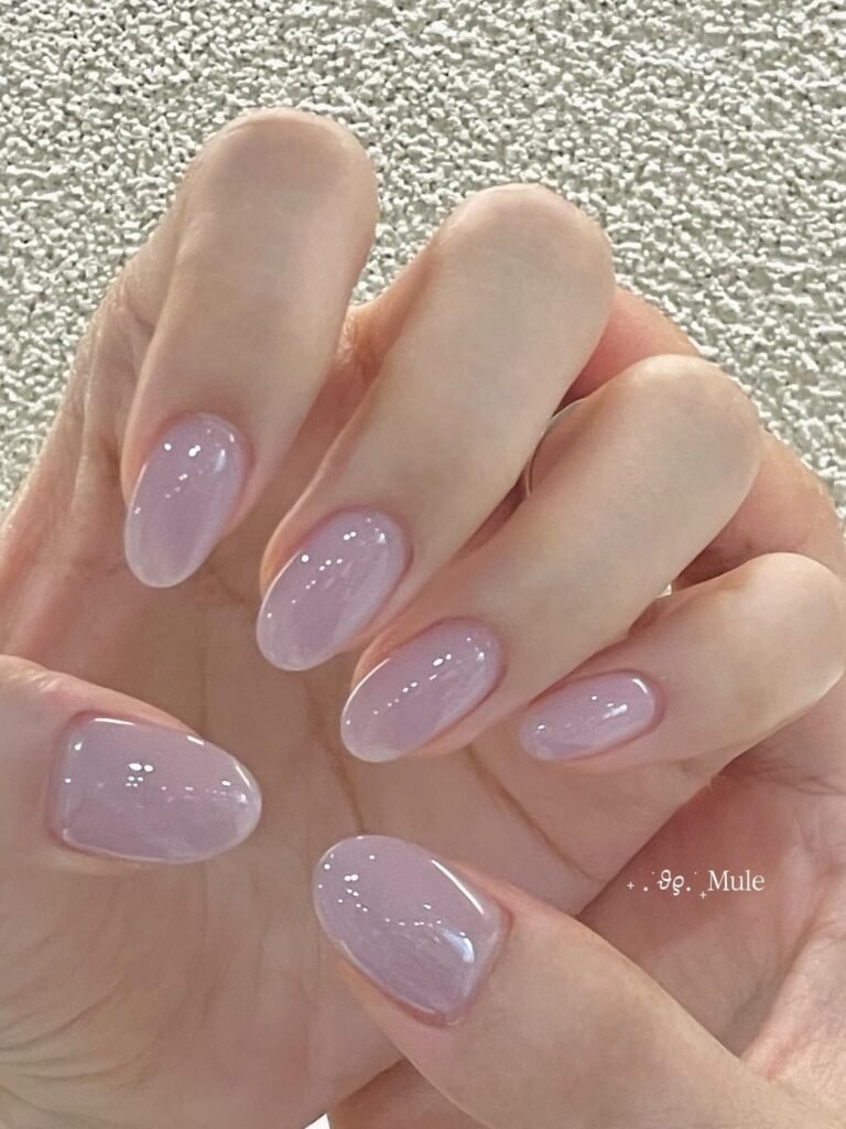 Soft dusty lilac almond nails with a high shine finish for spring.