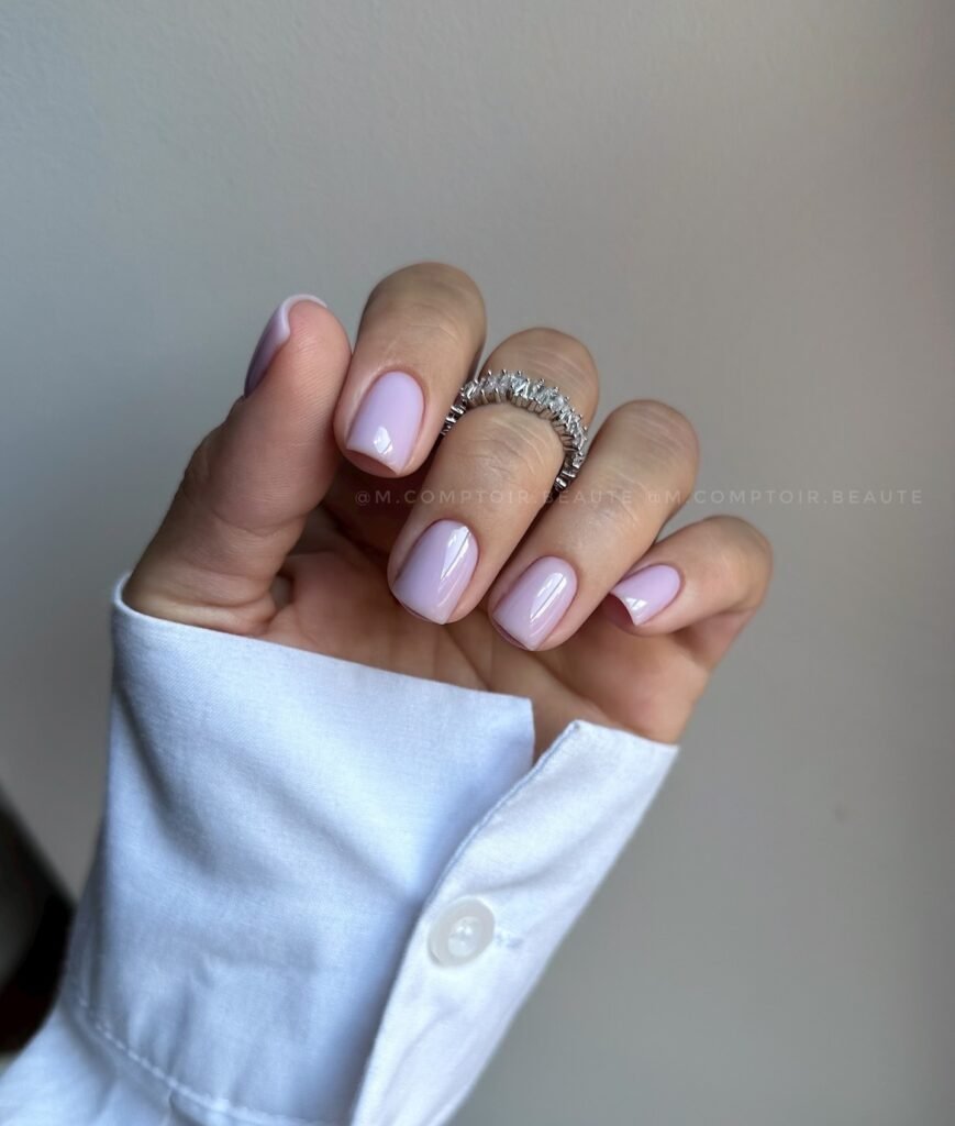 Minimal pale lilac square nails styled with a polished clean look.
