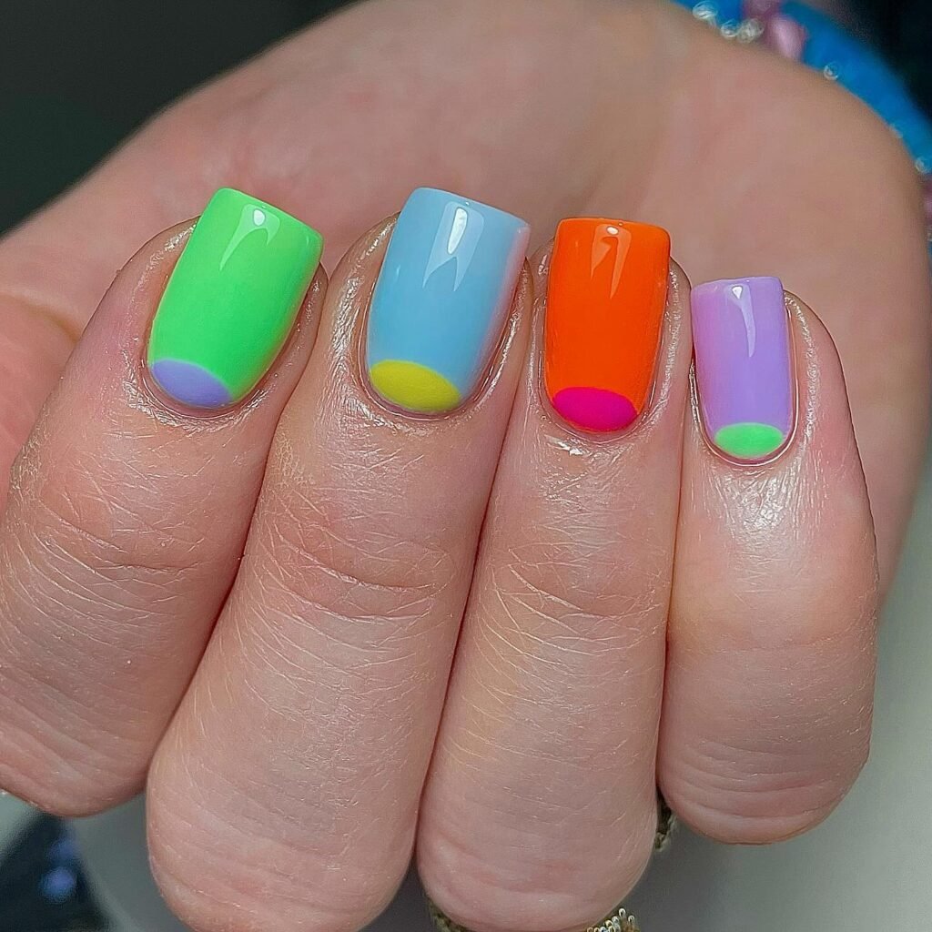 Bright colorblock nails with rainbow half moon tip accents