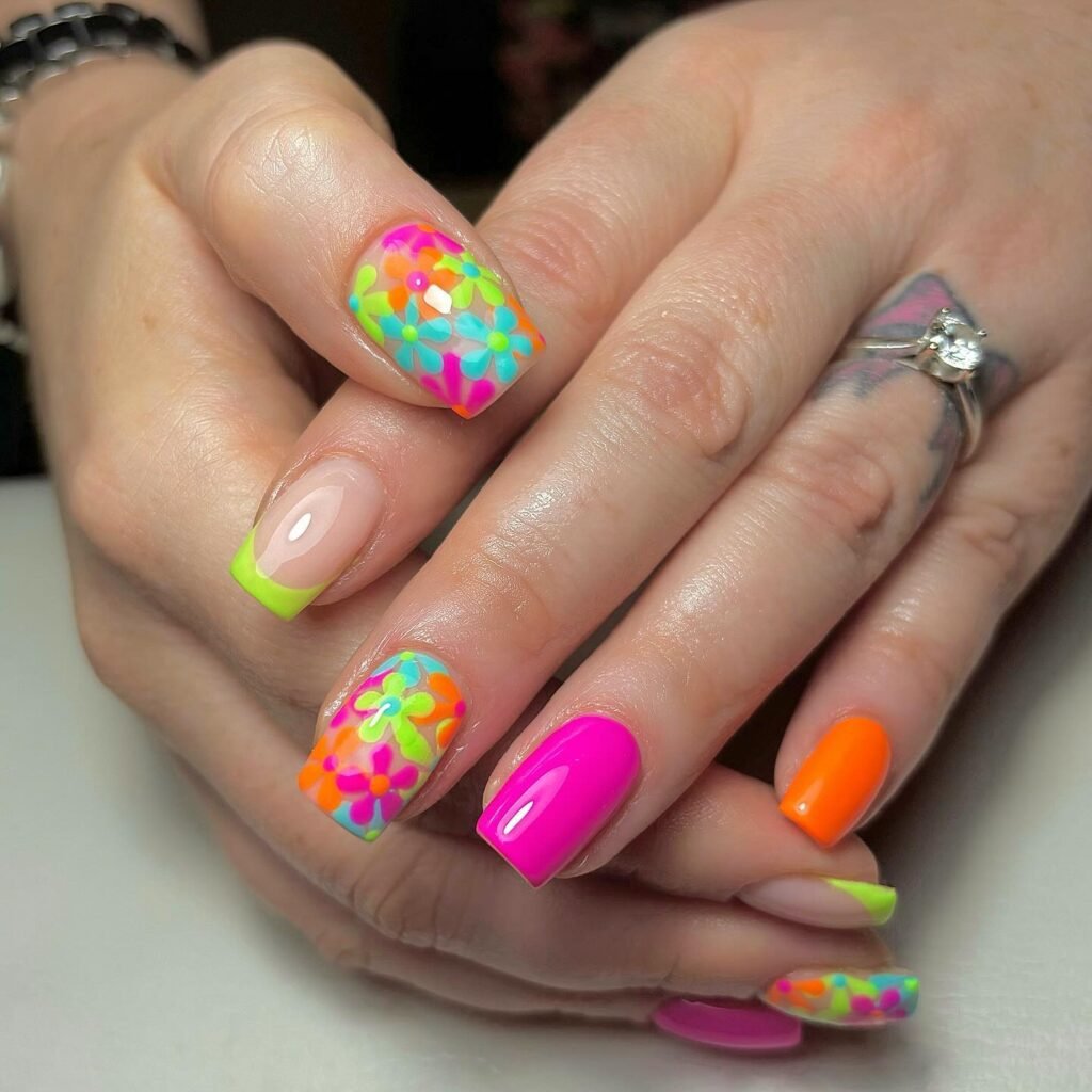 Neon rainbow flower nails with pink and orange accents