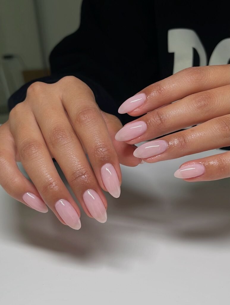 baby pink invisible French almond nails with glossy finish