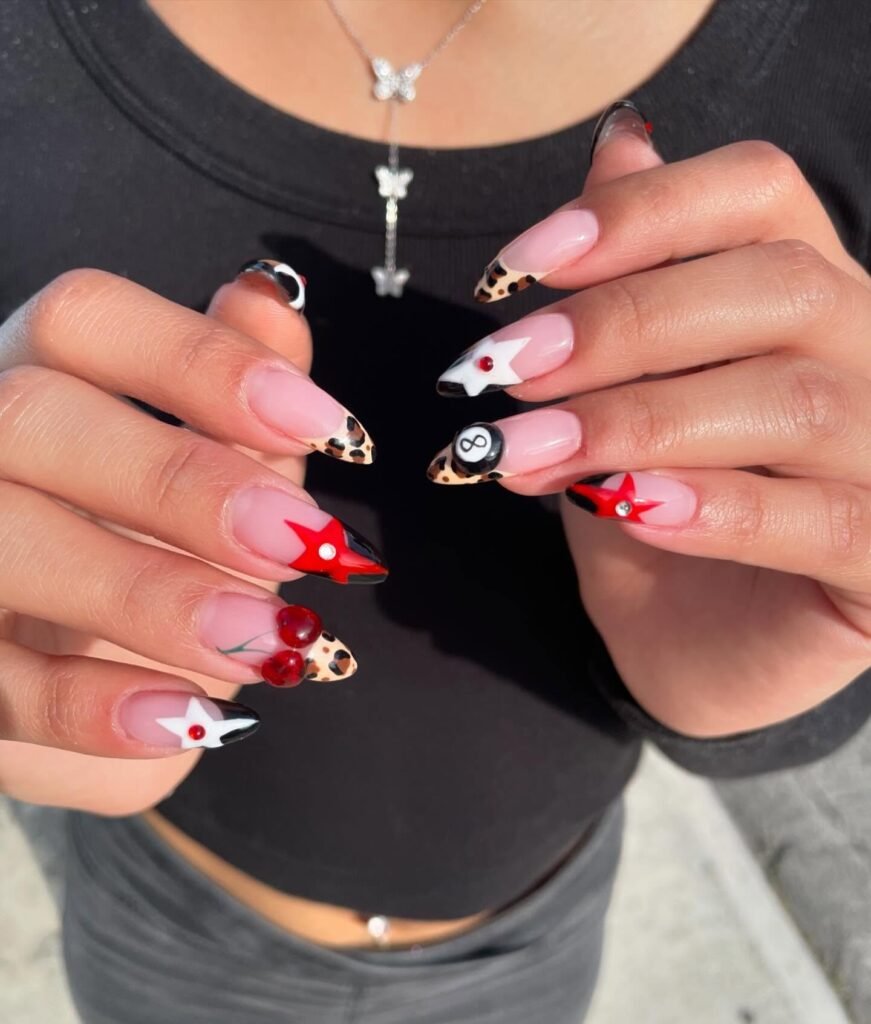 edgy Y2K cherry nails with leopard tips and stars