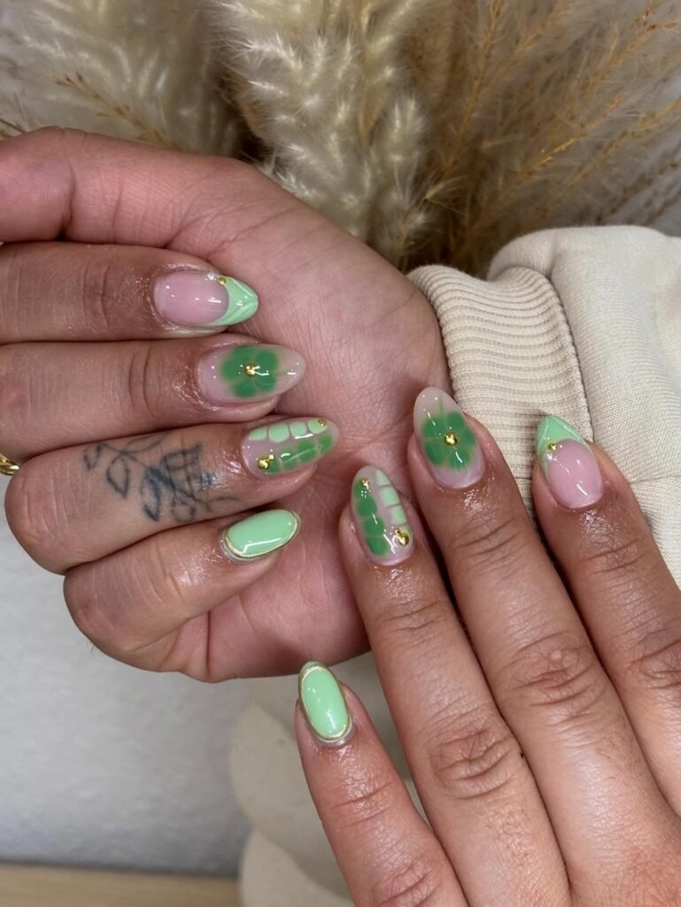 pistachio green floral nails with gold stud accents