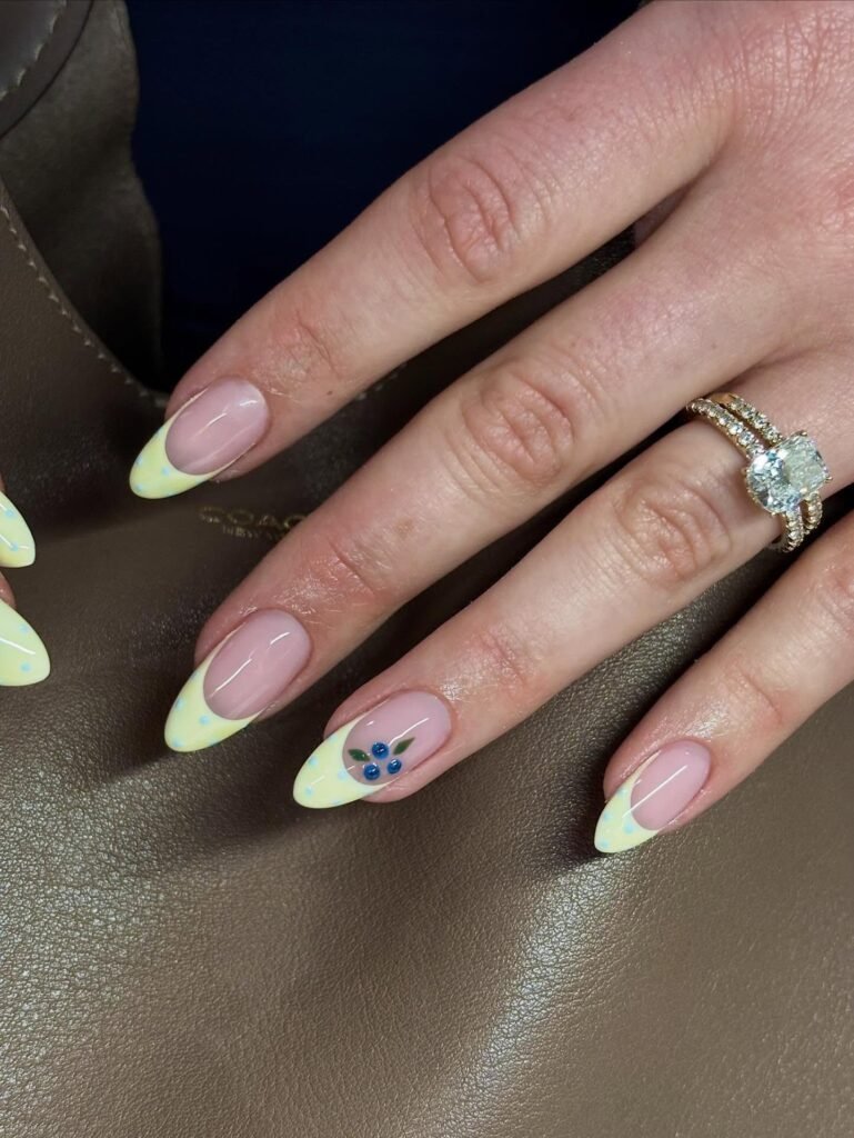 pistachio French tip nails with tiny blueberry accent