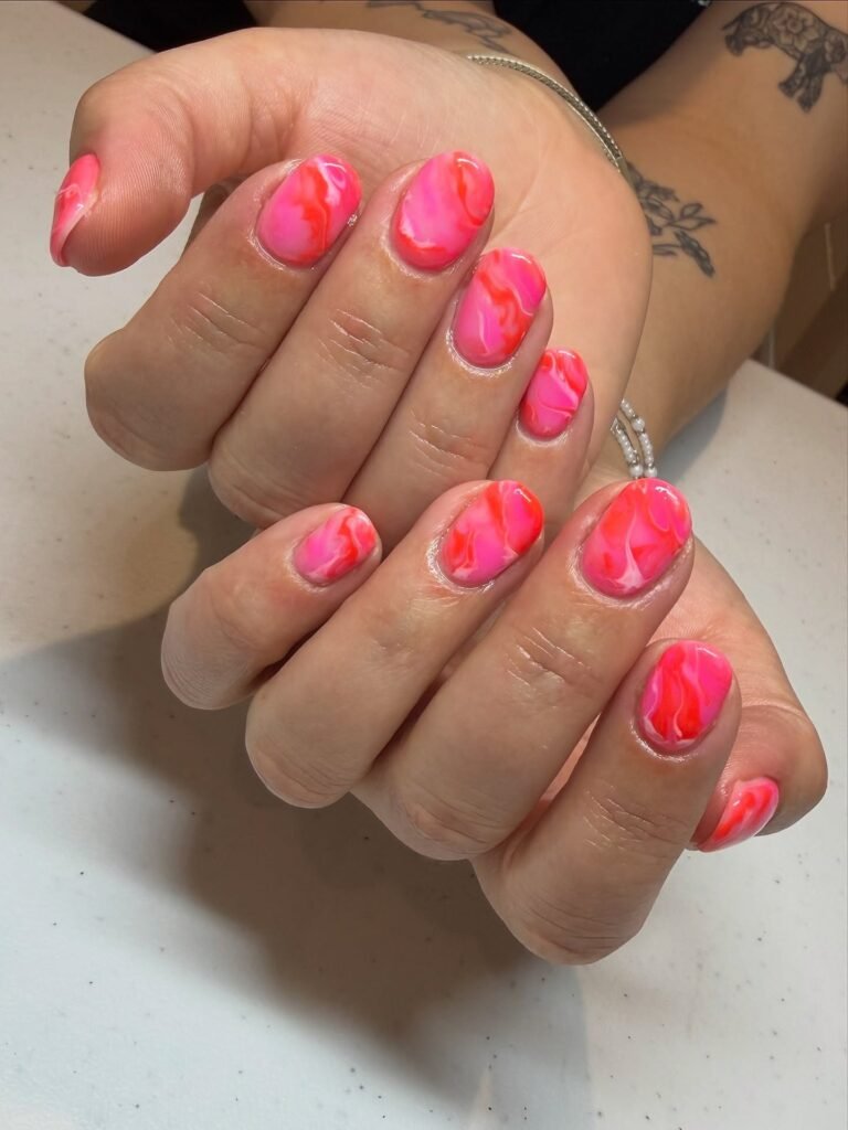 hot pink marble June nails with coral swirls