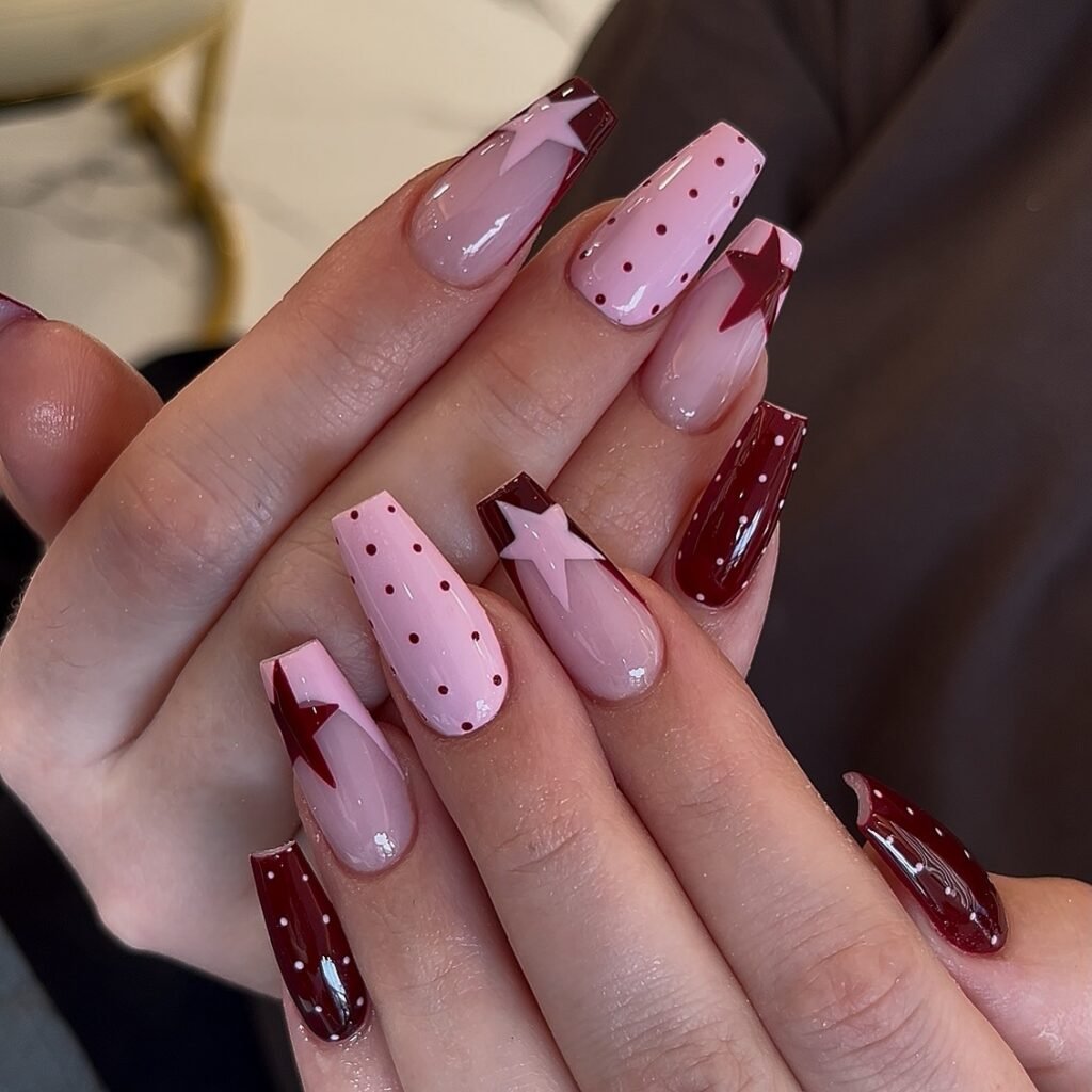 burgundy pink June nails with stars and dots