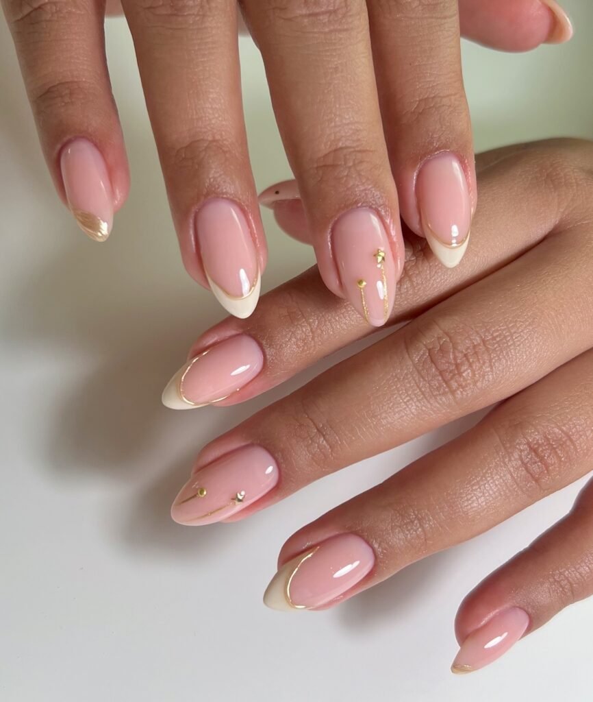 pink June French nails with gold accents and stars