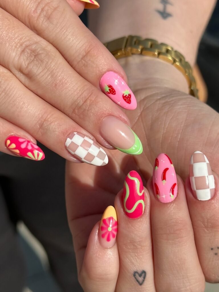 pink fruit nails with checkerboard and colorful swirls
