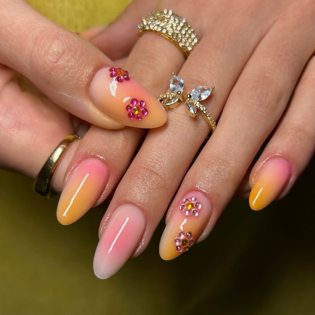 pink and yellow ombré nails with rhinestone flowers