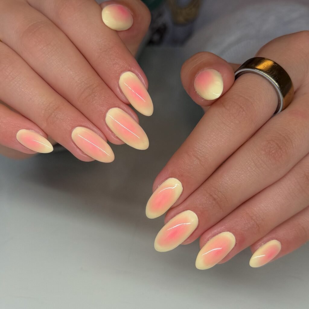 soft pink and yellow aura almond nails