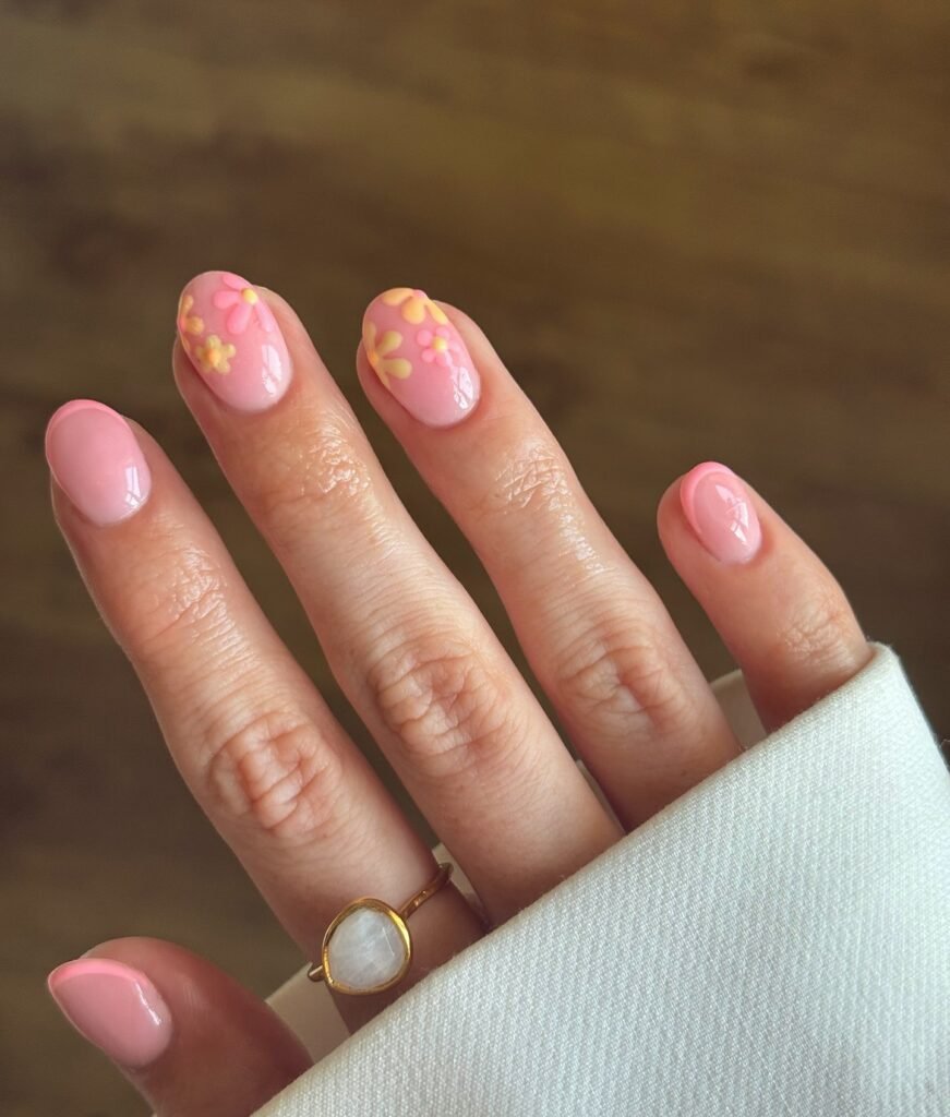 short pink nails with yellow floral accent art