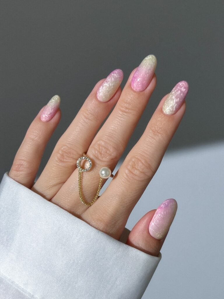 shimmery pink and yellow marble almond nails