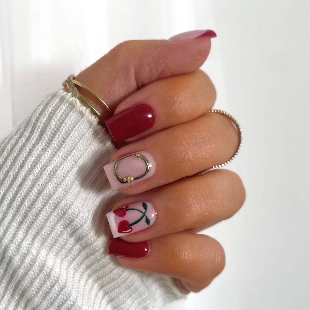 red square cherry nails with pink accent and gold detail