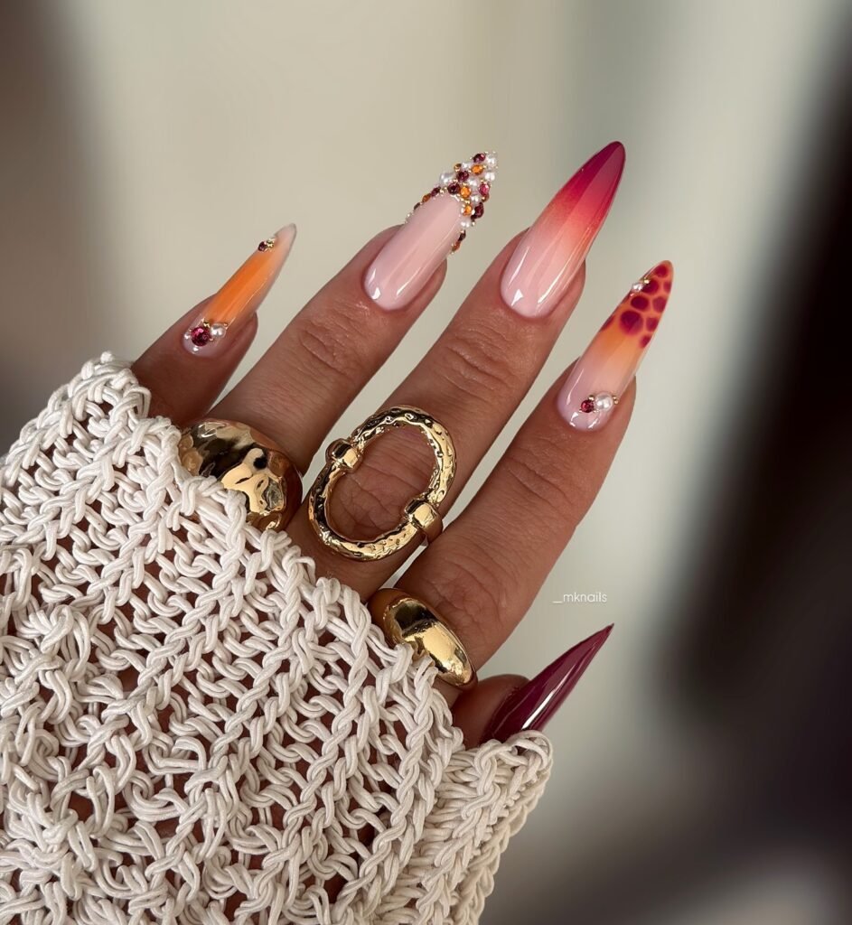 Rhinestone sunset stiletto nails with orange pink ombré