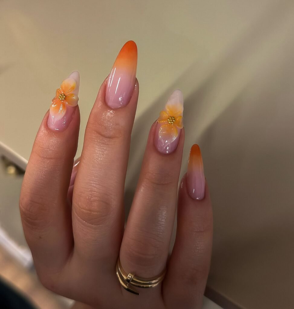 Peach ombré sunset nails with yellow flower accents