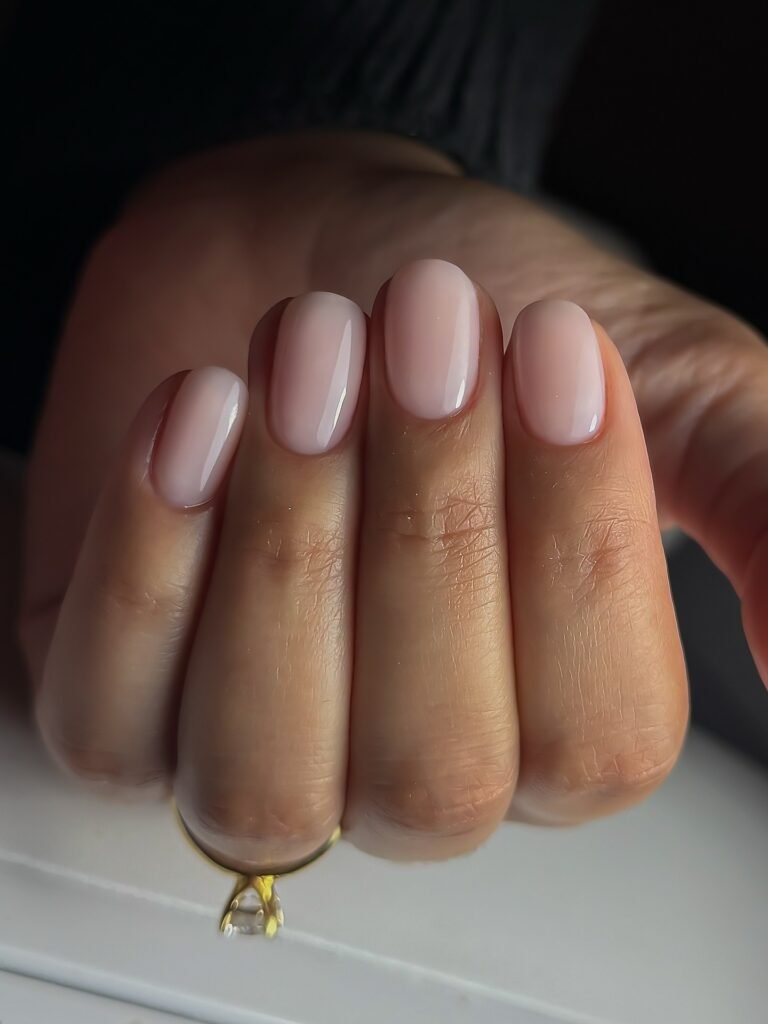 Pale pink oval nails with glossy salon finish