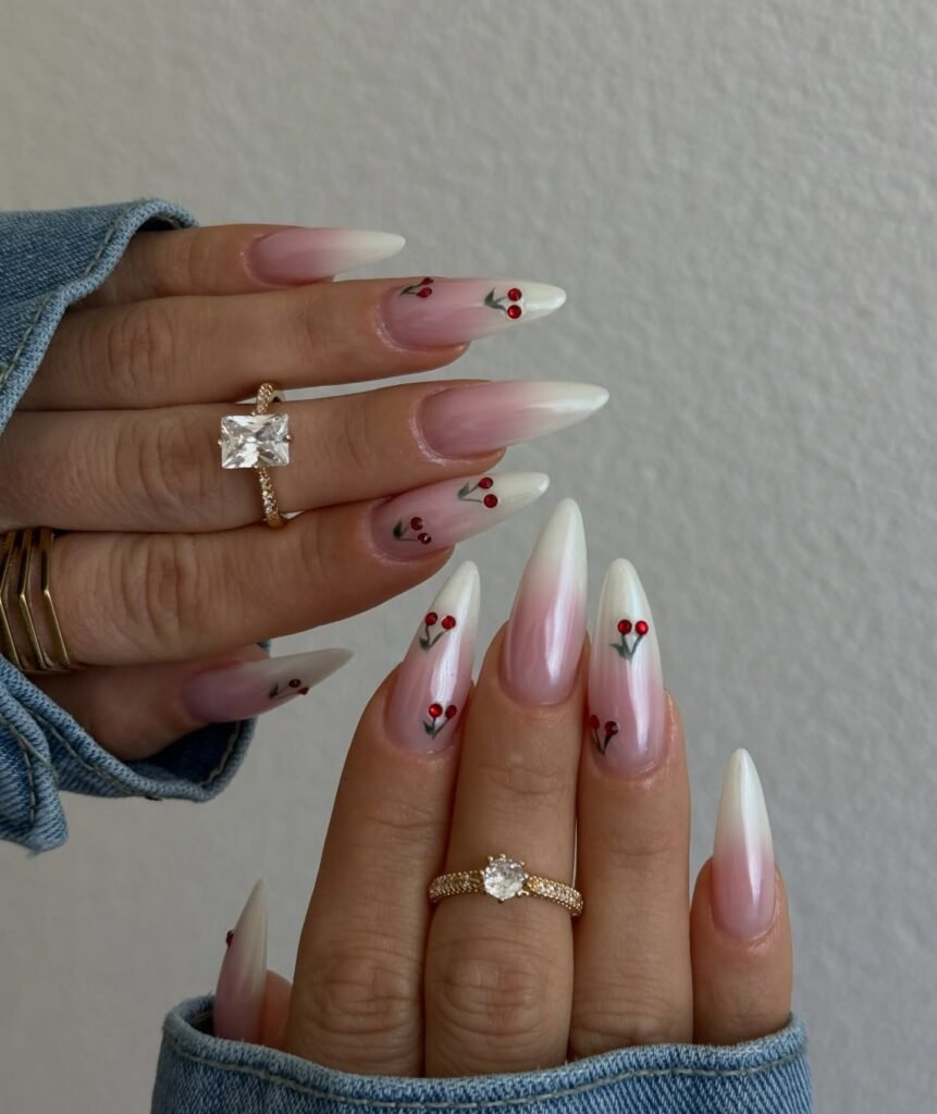 soft ombré almond cherry nails with red gem accents