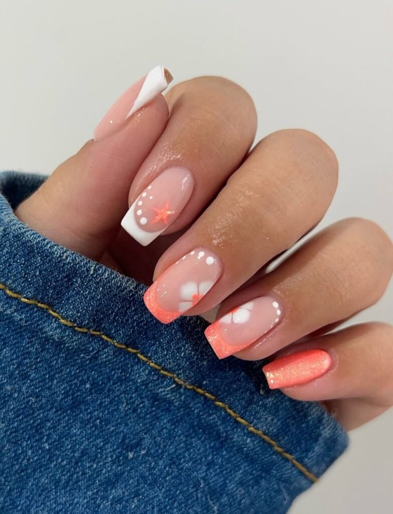 Coral French nails with white dots and soft shimmer accents