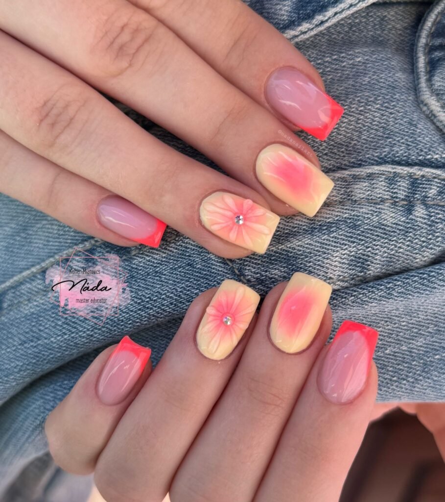 Coral aura nails with floral accents and bright French tips