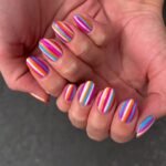 bright striped nail design with pink orange blue lines