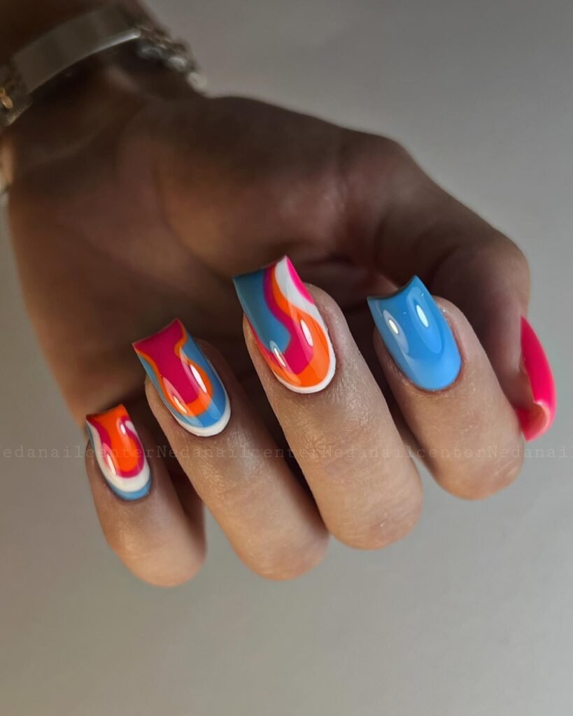 Bold rainbow swirl nails with blue orange pink polish