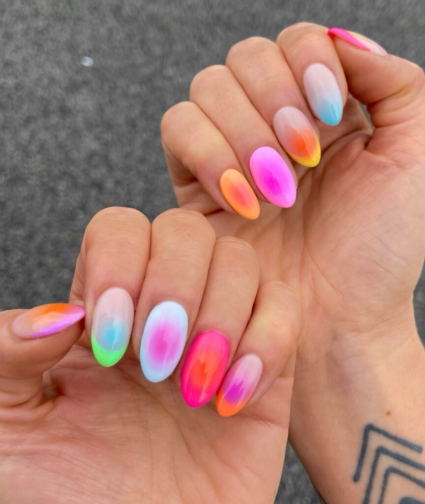 Soft rainbow aura nails with blurred neon summer colors